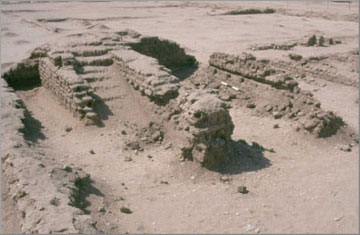 A view of the chambers in the north court, showing the remains of a staircase. The scale marks the location of a groove, once the location of a wooden beam, as illustrated above